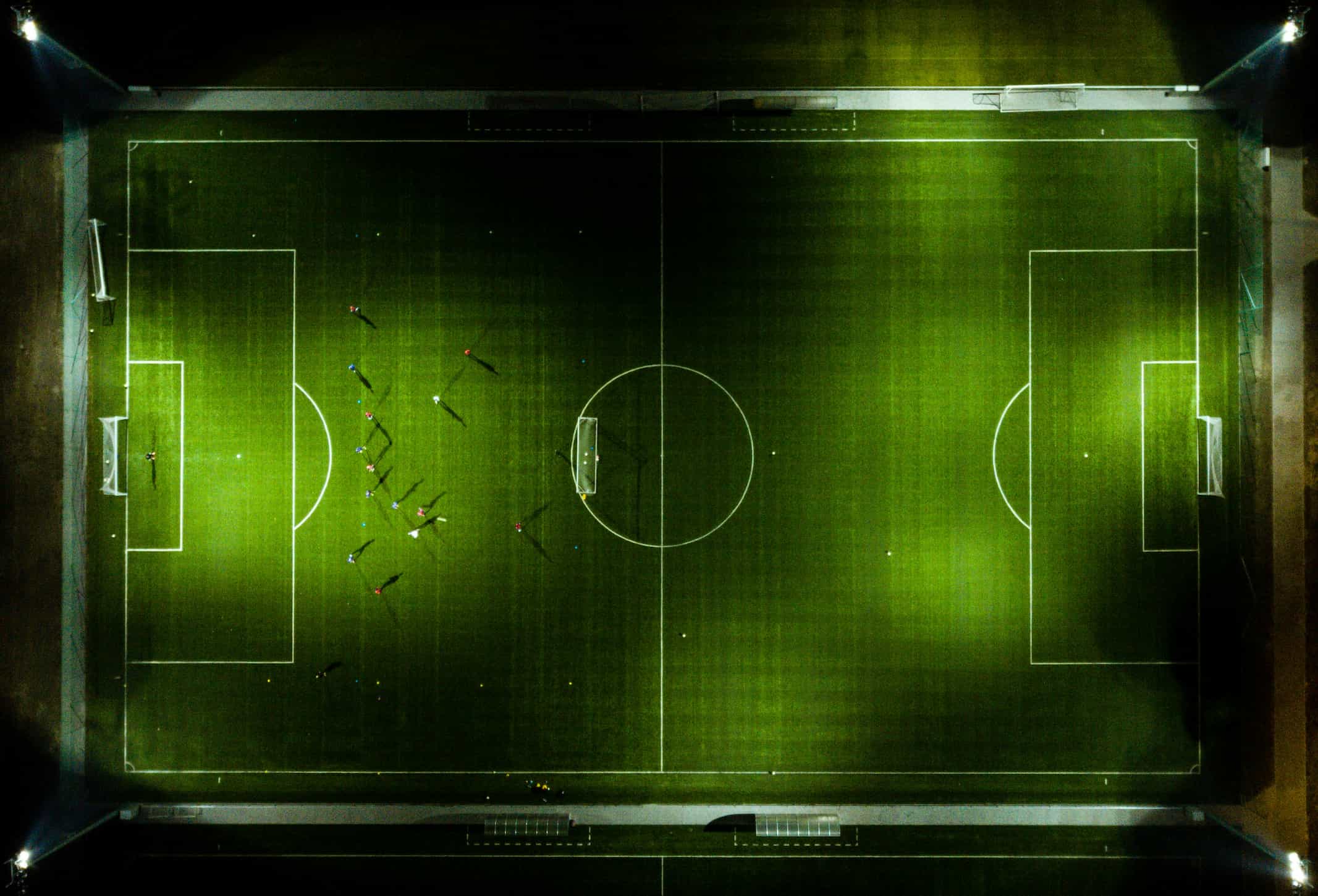 Football pitch from an aerial view with players.
